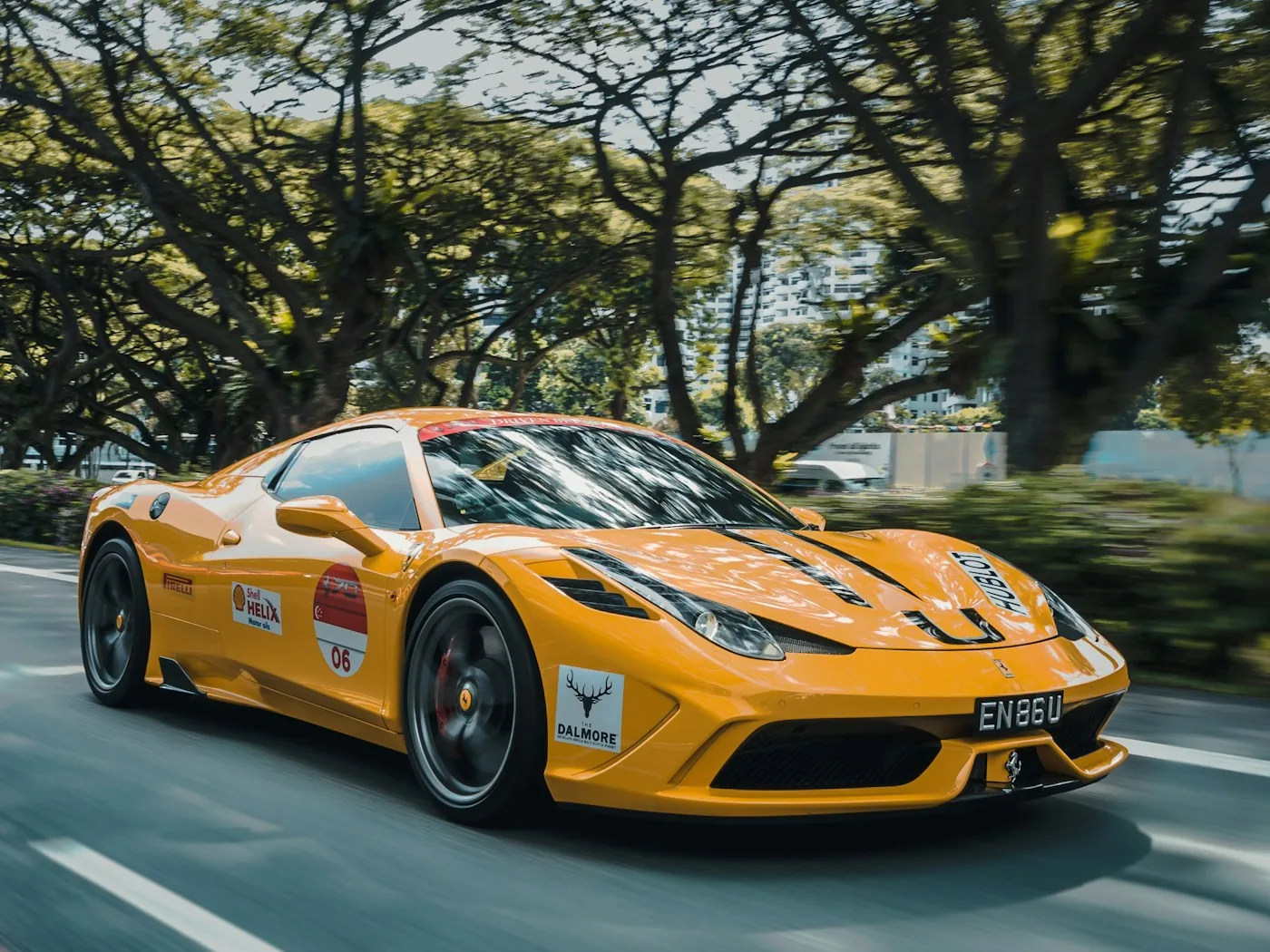 Yellow Ferrari 458 photographed on a leafy road